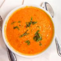 Dal Tarka · Cooked yellow lentils tempered with spices and  tomatoes made home-style