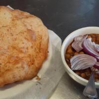 Chana Bhatura · Chickpeas cooked with tomatoes, onions and spiced. Served with fried dough.
