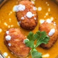 Malai Kofta · Chef's special dumplings are in white gravy, sliced and filled with cream, nuts and coconut.