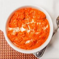 Chicken Tikka Masala · Grilled chicken cooked in a tomato butter sauce with mild spices. Served with a side of rice.