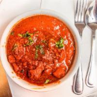 Lamb Rogan Josh · Aromatic lamb pieces cooked in a rich red sauce. Served with a side of rice.