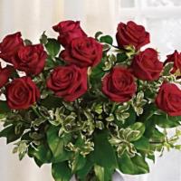 1 Dozen Red Roses In A Glass Vase · 1 Dozen Premium  Roses Arranged elegantly in a Clear Glass Vase With Greens and Baby's Breath.