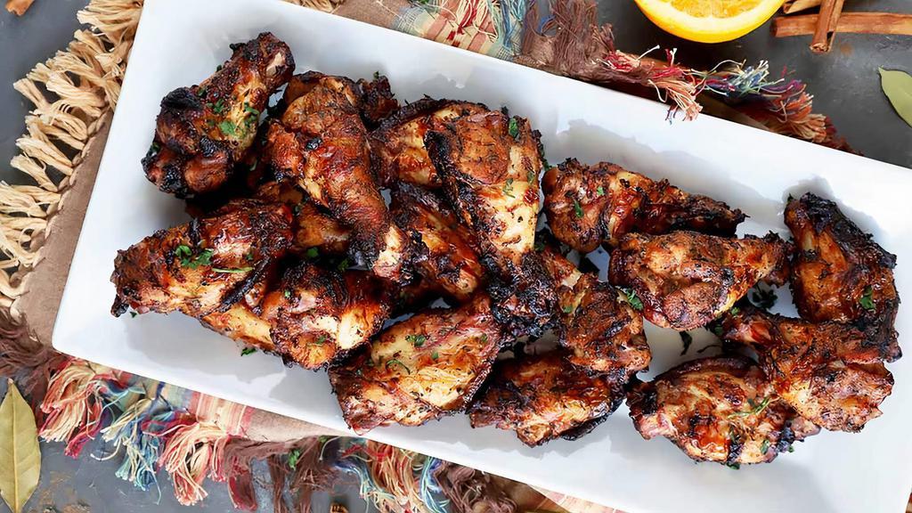 Jerk Chicken (Wings) · Served with your choice of two sides.