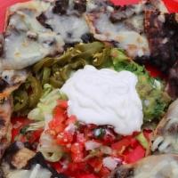 Nachos · Individually topped nachos with black beans and melted Chihuahua and Monterey Jack cheeses a...