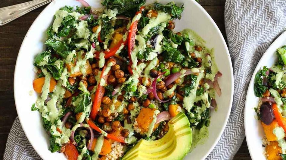 Tahini Kale Bowl · Kale, quinoa, sweet potatoes, red pepper, red onion, parsley, cilantro, avocado, roasted chickpeas, lemon tahini dressing.