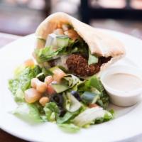 Darna Falafel  · Falafel, tomatoes, cucumber, romaine lettuce and tahini dressing on pita bread. Served with ...