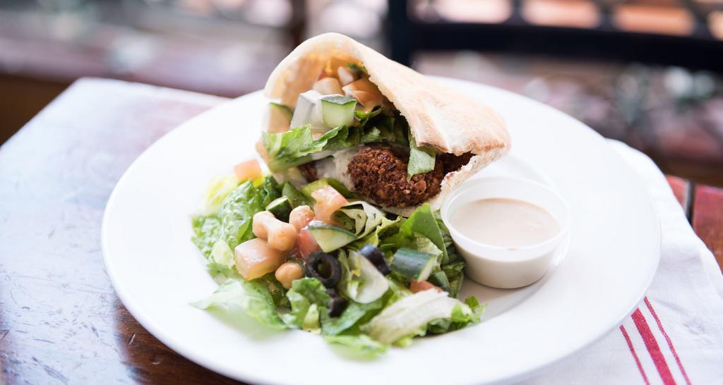 Darna Falafel  · Falafel, tomatoes, cucumber, romaine lettuce and tahini dressing on pita bread. Served with side salad.