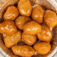 Loukoumades (Honey & Cinnamon) · Fried dough balls soaked in honey topped with cinnamon