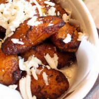 Tajadas · Sweet plantains topped with fresh cheese.