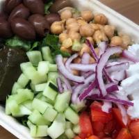 Greek Salad · Kalamata olives, vegan feta, grape leaves, chickpeas, onions, tomato, cucumber...all over ch...