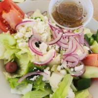 Greek Salad · Lettuce, tomato, cucumber, peppers, onions, Feta, olives, stuffed grape leaves, anchovies, g...