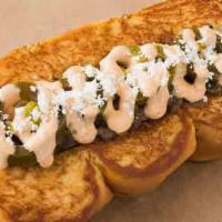 Old Town · Smoked bacon dog, caramelized onions, chipotle aioli, pickled jalapeños, cotija cheese.
