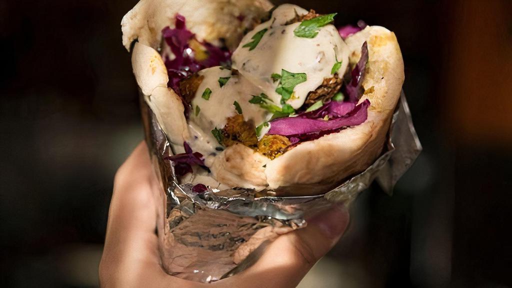 Shawafel Pita · Chicken shawarma sauteed w/ onions, classic falafel, hummus, red cabbage salad, tahini