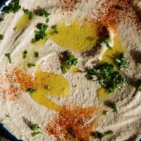 Hummus Plate · topped with tahini and warm chickpeas and pita