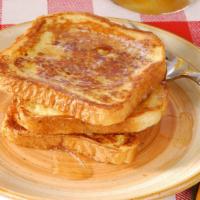 French Toast · Classic french toast topped with sugar and served with meat and eggs on the side.