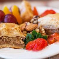 Baklava · Our homemade baklava served with dried fruits filled with mascarpone cheese.