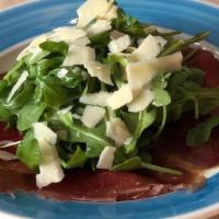 Carpaccio Di Bresaola · Carpaccio di bresaola (cured beef) with arugula and shaved Parmigiano topped with lemon dres...