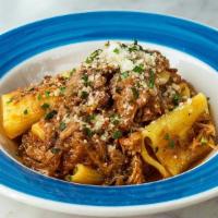 Paccheri Genovese · Homemade Jumbo rigatoni with slow cooked onion ragu, veal and Parmigiano reggiano.