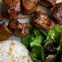 Lamb Shish · 2 Skewers of grill baby lamb served with rice and mix green salad.