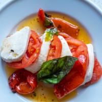 Insalata Caprese · Fresh mozzarella, fresh tomatoes, roasted peppers, basil and balsamic vinegar.