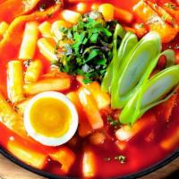 Ddukboki / 떡볶이 · Ddukboki with rice cakes, fish cake, boiled egg, and vegetables in a sweet and spicy sauce.