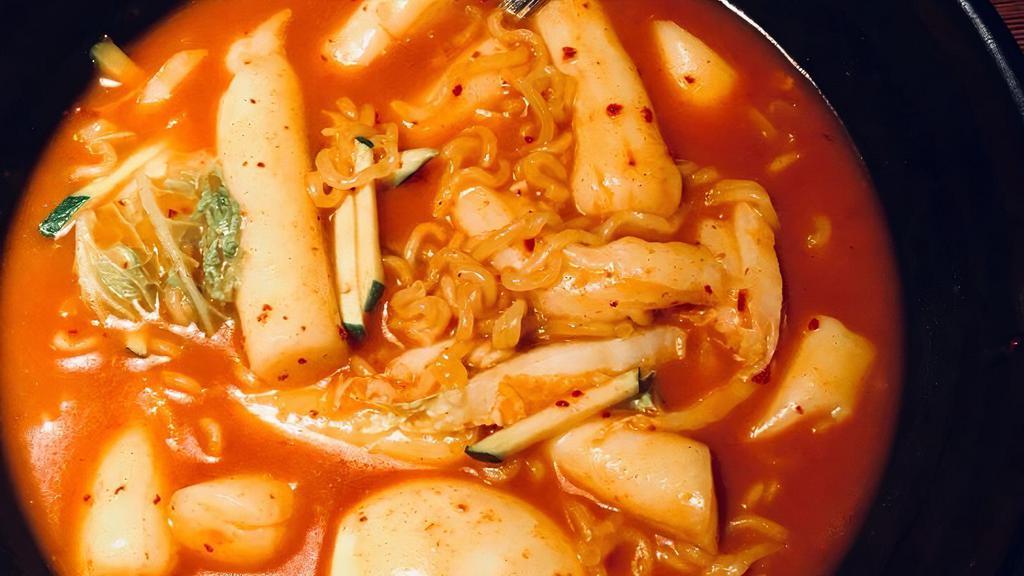 Ramen Dukbokki / 라면떡볶이 · Ddukboki with ramen noodles, rice cakes, fish cake, boiled egg, and vegetables in a sweet and spicy sauce.