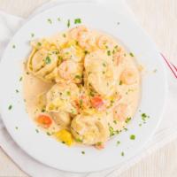 Lobster Ravioli · House specialty. Homemade ravioli stuffed with lobster and topped with shrimp, sun-dried tom...