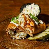 The Englishman · Wrapped with crispy beer battered cod, slaw, and seasoned fries.