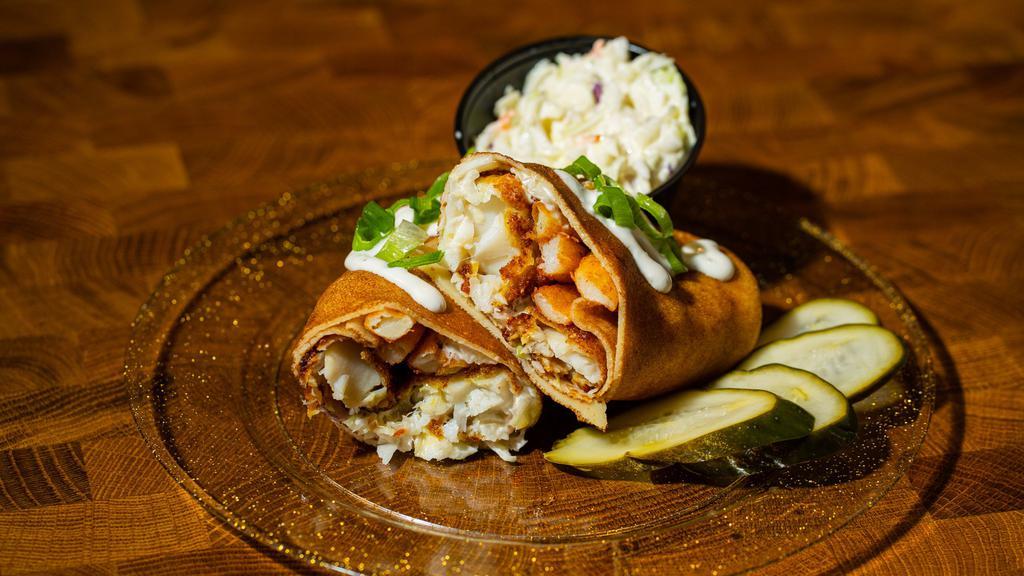 The Englishman · Wrapped with crispy beer battered cod, slaw, and seasoned fries.