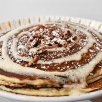 Cinnamon Roll Pancakes · Cinnamon swirl buttermilk pancakes with creamy butter pecan filling, topped with cream chees...