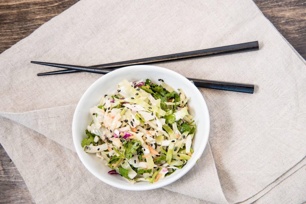 Edamame Slaw · Gluten free. Vegan. Cabbage slaw with edamame with cilantro, scallions, carrots, sesame lime vinaigrette, and sesame seeds. Vegan. Gluten free.