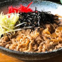 Gyu Don · Marinated and thinly sliced beef brisket cooked with onions served over rice, topped with pi...