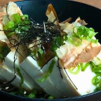 Hiyayakko · Tofu dressed with ginger, cold soba soup, and soy sauce, topped with bonito flakes, green sc...