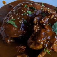 Chicken Mole Poblano Platter · Bone in chicken served in mole sauce and sesame seeds on top