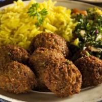 Falafel Over Rice · Falafel with rice, salad and white sauce.