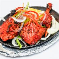 Tandoori Chicken · Chicken marinated in yogurt, mild spices and roasted over charcoal in the tandoor.