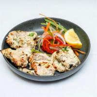 Chicken Malai Kebab · Boneless pieces of chicken breast marinated in ginger and garlic malai sauce flavored with s...