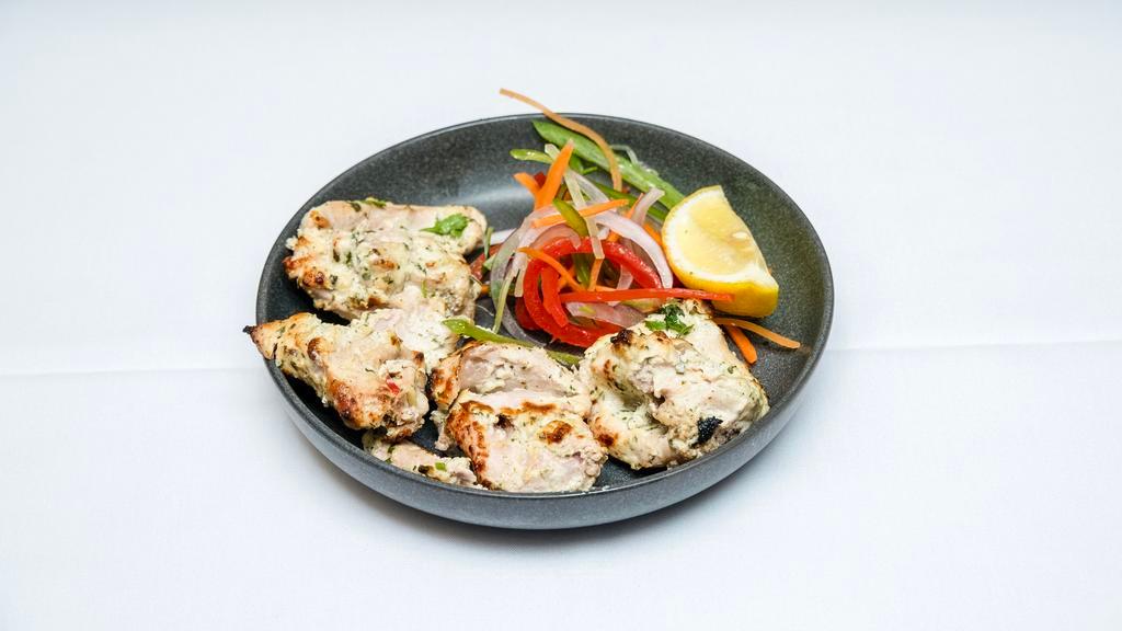 Chicken Malai Kebab · Boneless pieces of chicken breast marinated in ginger and garlic malai sauce flavored with saffron and cinnamon - cooked to melt-in-your-mouth tenderness in a clay oven.
