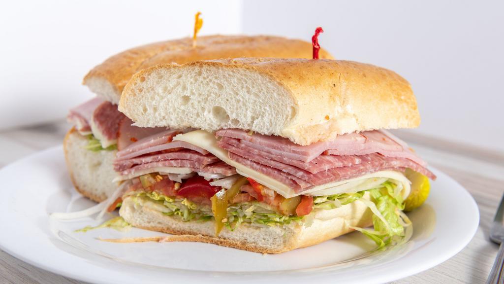 The Godfather Deluxe Hero Sandwich · Genoa salami, provolone, cappy ham, hot & sweet peppers, onions, lettuce, tomato, oil & vinegar. Served with coleslaw, pickle & French fries or salad.