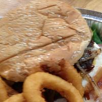 Cowboy Burger Deluxe · Hamburger, cheddar cheese, sauteed onion and BBQ sauce. Served with lettuce, tomato, colesla...