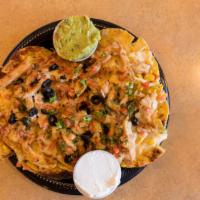 Gringo Nachos · Melted cheese over hot nachos with grilled chicken and corn, topped with salsa, pico de gall...