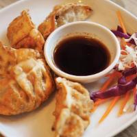 Gyoza · Chicken or vegetable, scallion, ginger, garlic served with sweet, chili and garlic soy sauce.