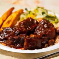 Stewed Oxtails · Our signature style stewed oxtail (bee)  served with rice or mac 'n cheese, vegetable and sw...