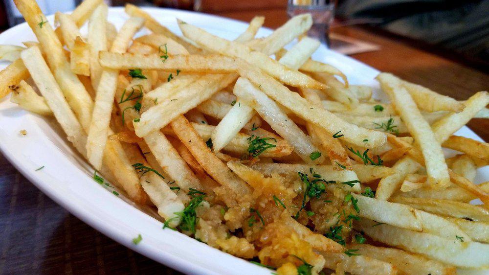 French Fries · Fresh cut daily potatoes deep fried served with garlic and dill.
