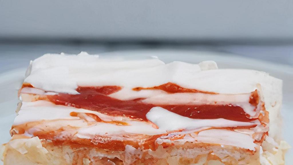 Homemade Delicious Guava Tres Leches Slice · This tres leche is sponge cake is soaked with cream and coconut milk and layered with guava puree. A magical twist on a classic cake.