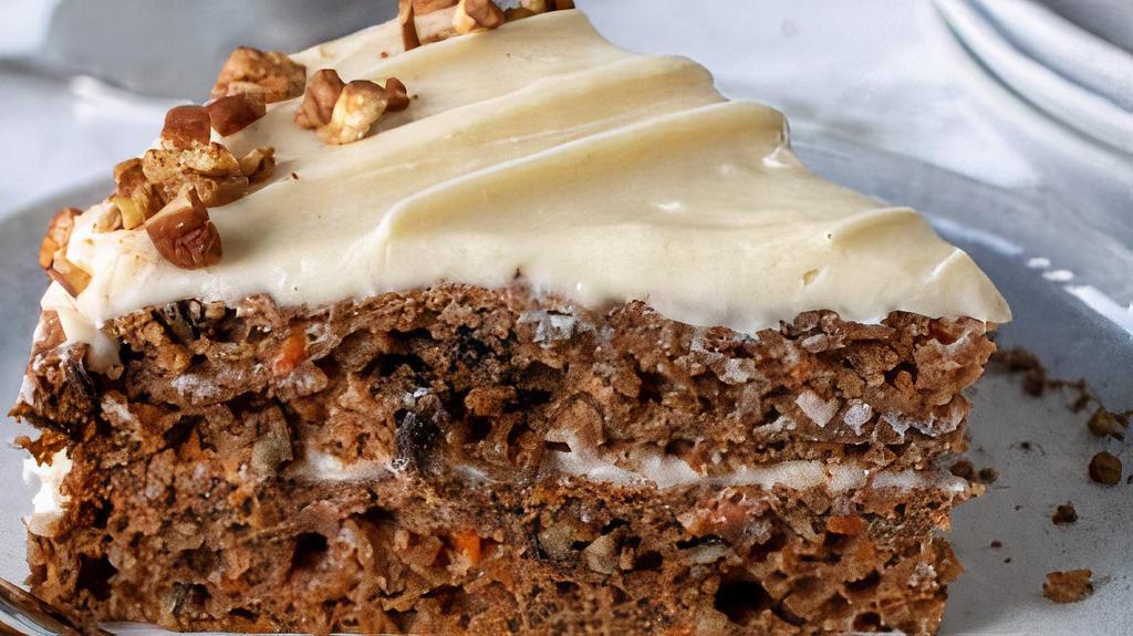Gluten Free Vegan Carrot Cake Slice · This flavorful, classic, moist gluten-free carrot cake topped with a tangy cream cheese frosting made just for you also it is raw, vegan and no sugar added..
