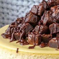 Fresh 8' Whole Brownie Cheesecake For 6 To 8 People · This rich masterpiece is topped with fudge icing, brownie pieces and chocolate ganache drizz...