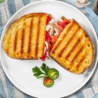 The Benigni Panini · Prosciutto di parma, homemade mozzarella, and arugula on freshly baked bread. Served with a ...