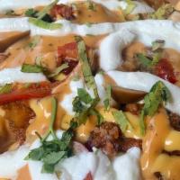 Nacho Fries · Serves 2. Fries, Beef Chili, Cheese, Hot Peppers, Sour Cream, Chipotle Honey Sauce