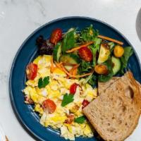Scrambled Eggs · Three Scrambled eggs served with fresh parsley and sauteed tomatoes with a slice of hearty w...